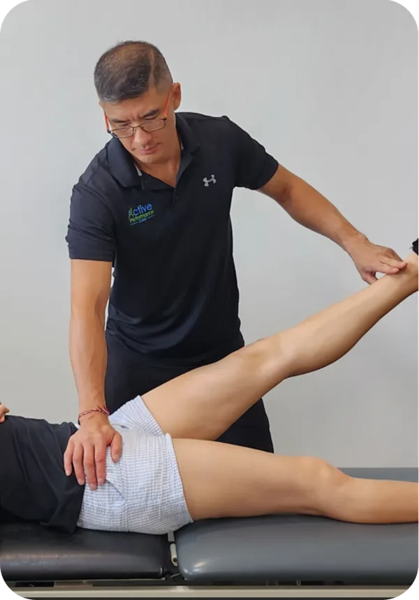 Practitioner assessing a client's knee at Active Performance Clinic